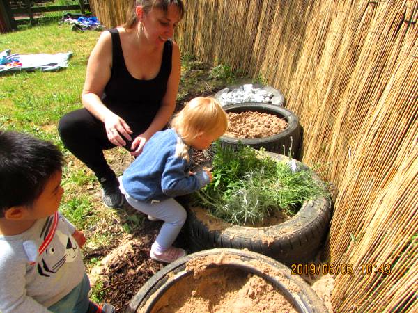 Staff member engaging with a child at Clever Cloggs