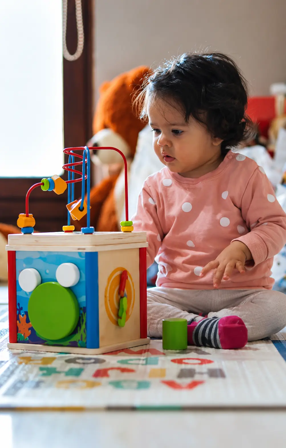 Child exploring educational activities at Clever Cloggs Nursery
